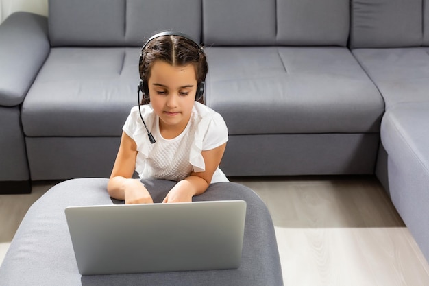 A young girl is attending online school or classes. Study in lock down as Schools closed due to Covid-19. technology during lockdown. Learning at home concept