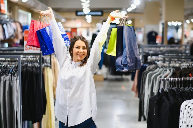 Young girl is choosing to buy clothes at the mall