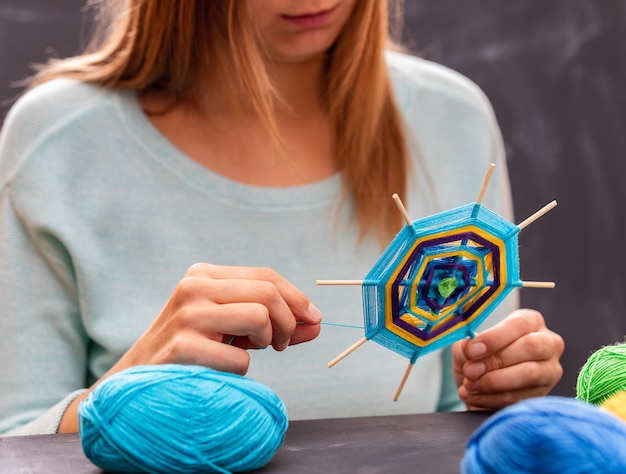 Young girl is doing handmade mandala 