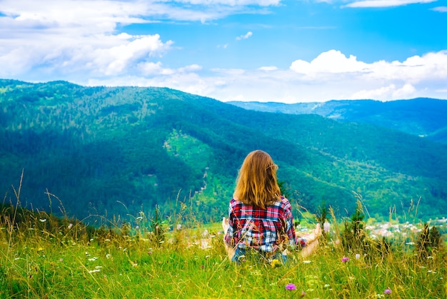 young girl is meditating in nature