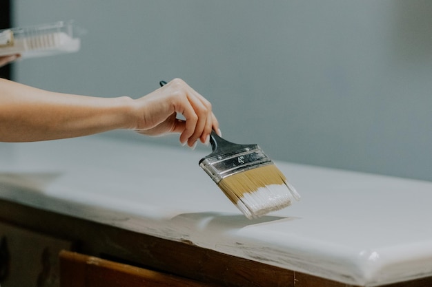 A young girl is painting an old closet