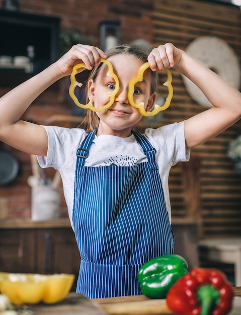 Young girl is playing in the kitchen