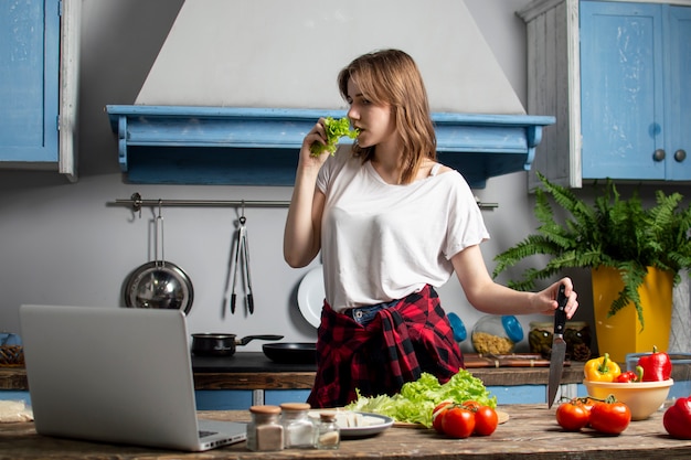 Young girl is preparing a salad