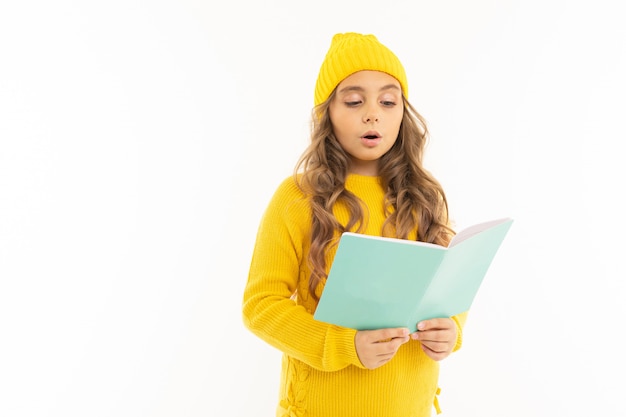 Young girl is reading a book on white