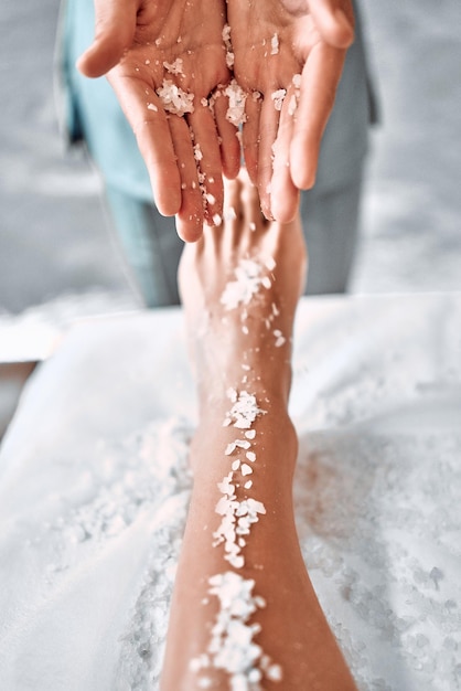 Young girl is relaxing in the spa Foot massage Vertical photo