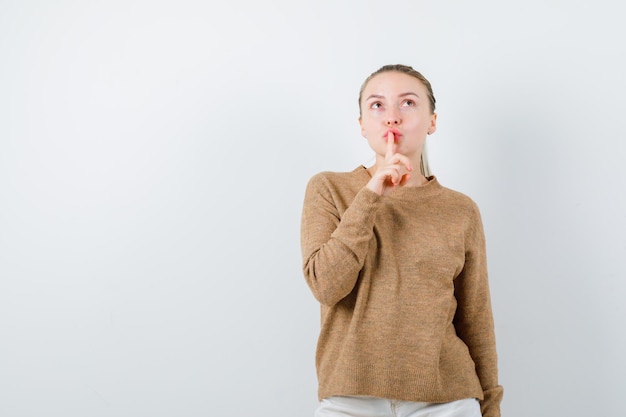 The young girl is showing Keep calm designation on white background