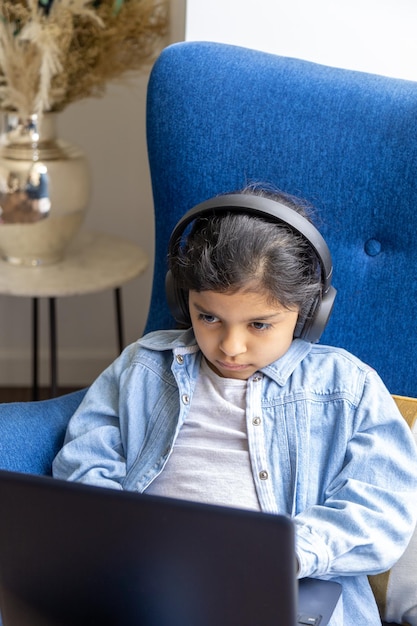 Young girl is using her laptop on the living room