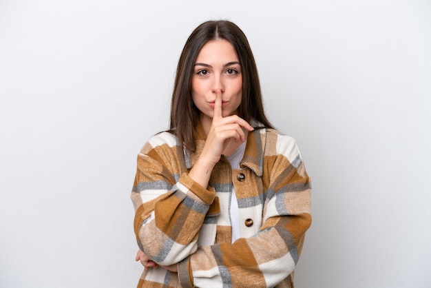 Young girl isolated on white background showing a sign of silence gesture putting finger in mouth