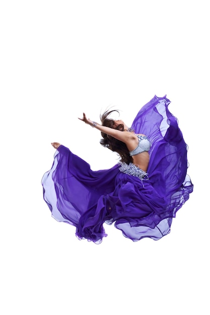 Young girl jump in purple oriental eastern veil