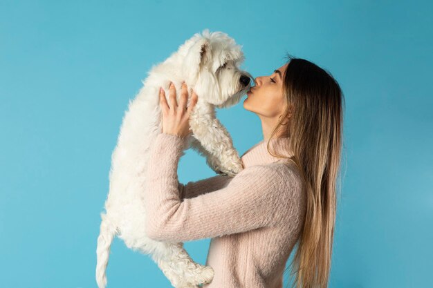 Young girl kissing a dog on the nose