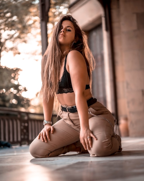 Young girl kneeling on the floor in an urban lifestyle session