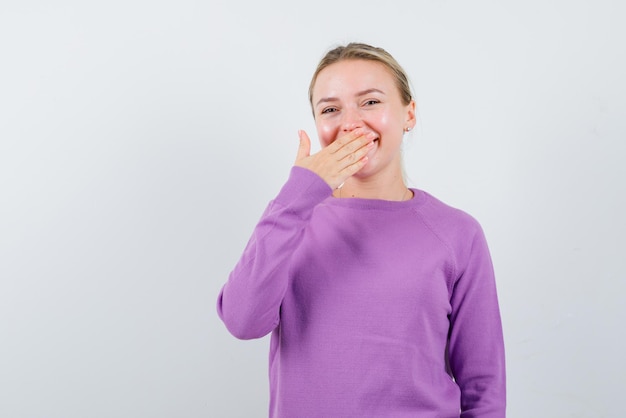 Young girl laughing on white background