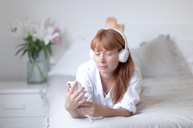 Young girl listening to music in bed Flower lily indoor