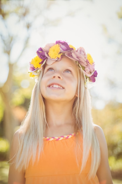 Young girl looking up and smiling in park