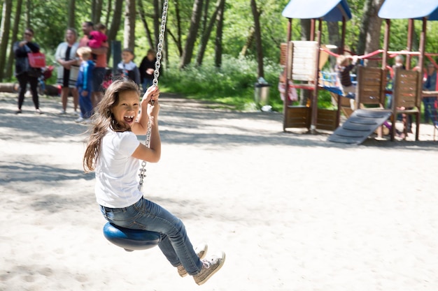 La ragazza fa la linea zip nel parco per i bambini