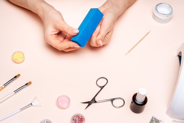 A young girl makes a manicure at home. Modern way of life.