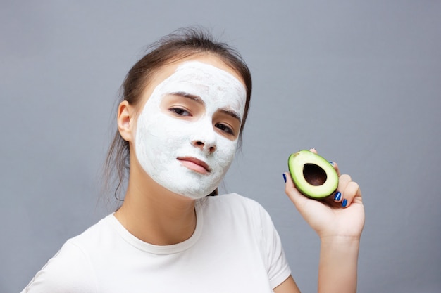 Young girl makes a moisturizing cleansing face mask