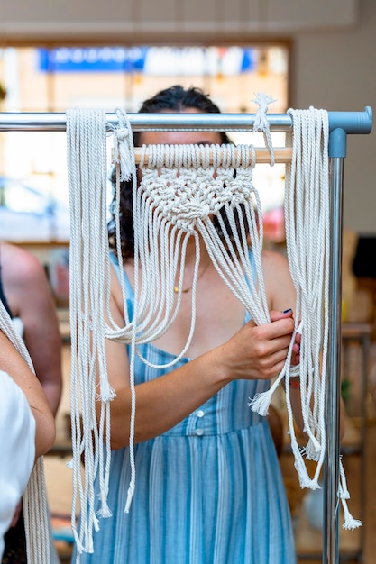 Young girl making macrame in a workshop