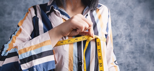 Young girl measures her breasts