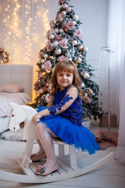 Young girl near chrismas tree