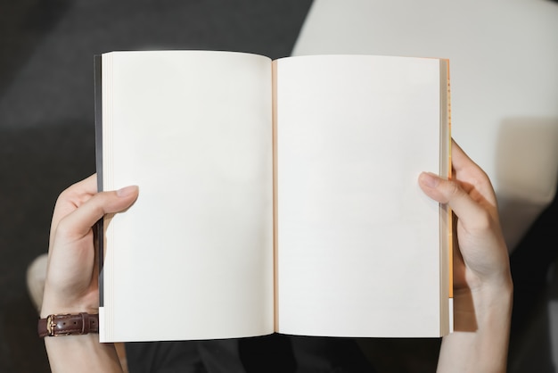 young girl open the pages of the book empty. text for banner lifestyle and school.