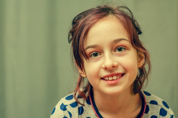 Young girl in pajamas. Girl in pajamas. Girl 9 years old in a gray dress with blue polka dots