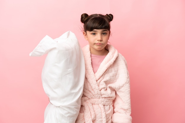 Young girl in pajamas over isolated background