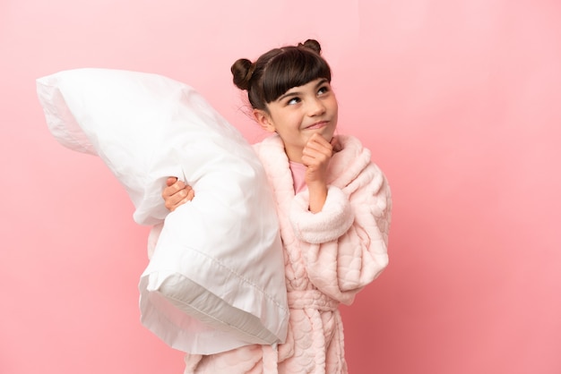 Young girl in pajamas over isolated background