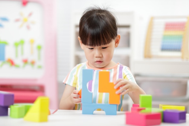 写真 家でおもちゃのブロックを遊ぶ若い女の子