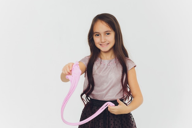 Young girl playing with slime. Isolated on white background.