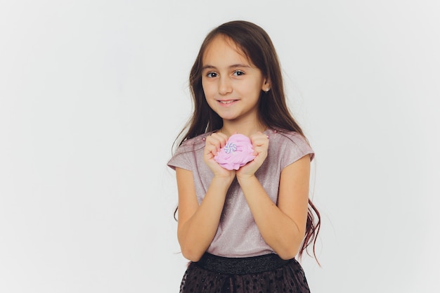 Young girl playing with slime. Isolated on white background.