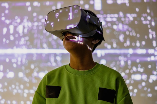 Young girl playing with virtual reality glasses