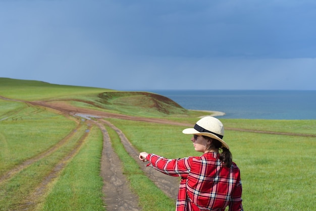 Young girl pointing her finger to the path of Cape Kharantsy