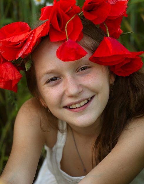 Young  girl portrait at the poppies field