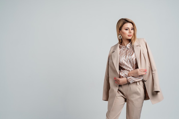 Young girl posing in a business suit Employee and business concept