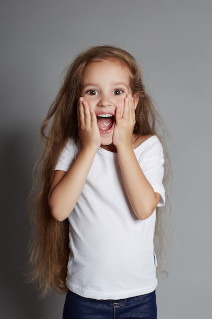 Young girl posing on gray, bright 