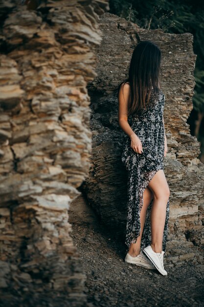 Young girl posing near cave entrance 