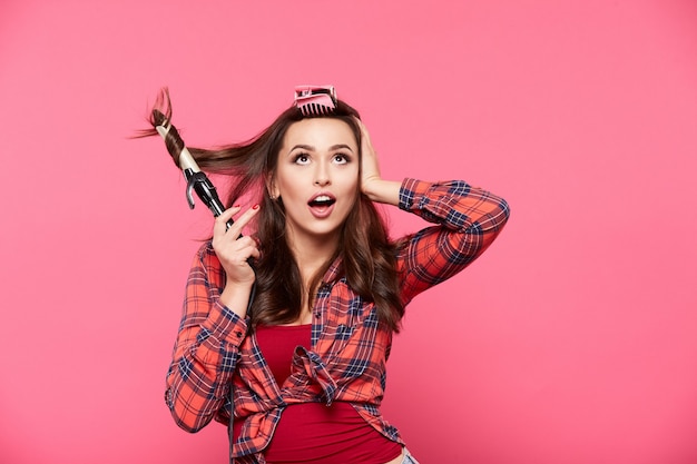 Young girl posing at pink wall