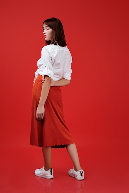 Young girl posing, wearing a shirt and a long skirt