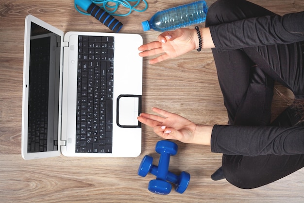 Young girl practicing yoga at home Online video training