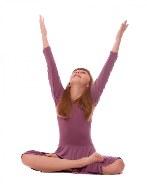 Young girl practicing yoga on white.