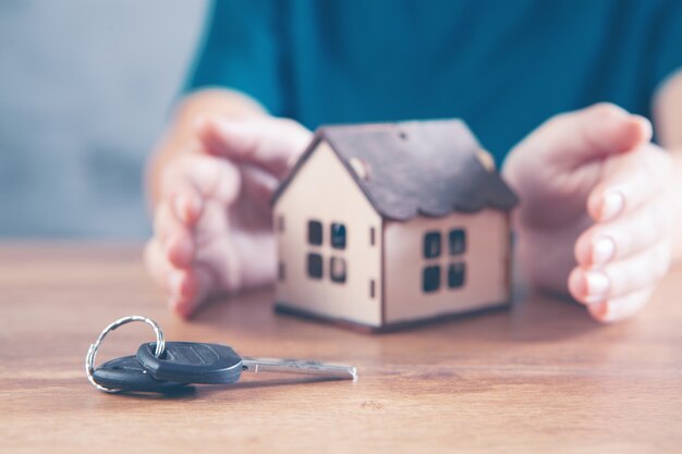 Young girl protects the house and near the keys