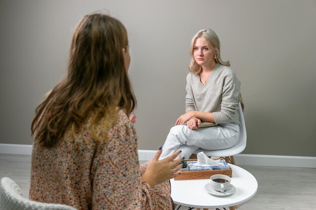 Young girl psychologist student listens to client