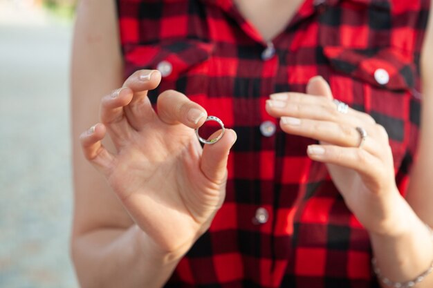 Photo young girl puts on a ring in the park