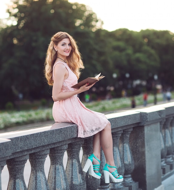 Young girl reading a book in the Park.