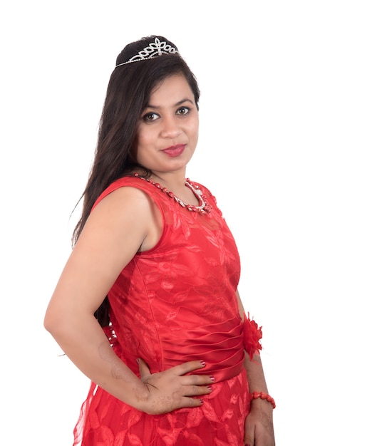 Young girl in red dress posing on white