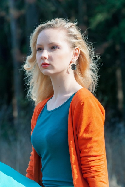 A young girl in a red jacket on the railway