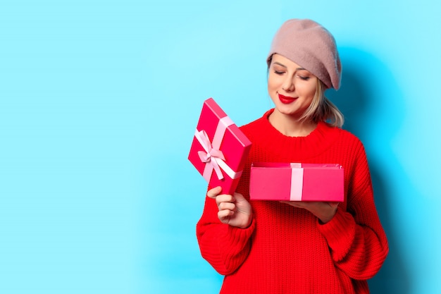 Young girl in red sweater with gift box