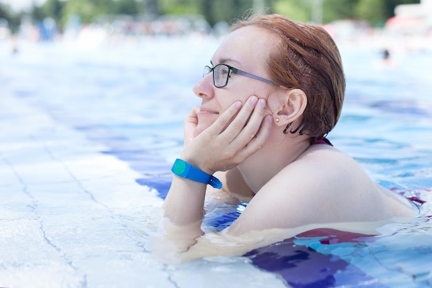 Young girl relaxing in the pool, healthy lifestyle