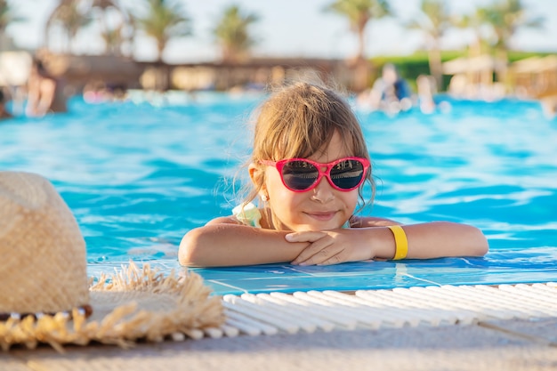  Young girl relaxing in the swimming pool